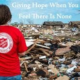 Salvation employee looking at tornado damage